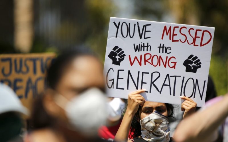 A protester at the Irvine Civic Center on June 13 holds a sign that says “You’ve messed with the wrong generation.” The protest was organized by Beckman High School students. (Raul Roa/Staff Photographer)